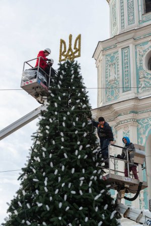 Photo for 2023-12-05 Kyiv, Ukraine. Municipal workers decorating the Christmas tree with glowing garlands - Royalty Free Image