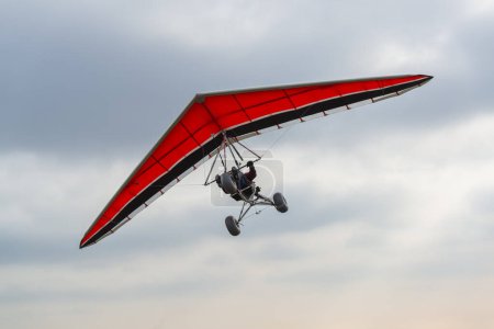 Photo for Red wing hang glider trike silhouette - Royalty Free Image