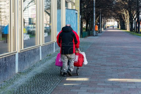 Photo for Homeless senior with bags full of returnable bottles , berlin, germany - Royalty Free Image