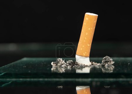 Photo for The cigarette butt. Stop smoking in any moment of your life! Isolated on black background - Royalty Free Image