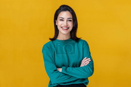 Photo for Shot of beautiful woman smiling while looking at camera on isolated on yellow - Royalty Free Image