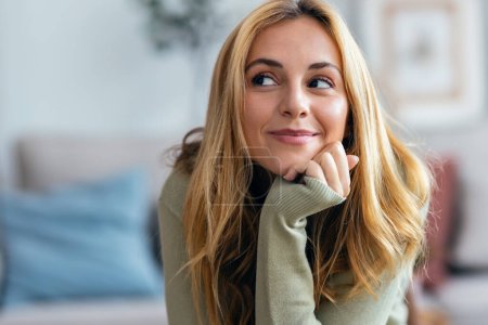 Photo for Portrait of cute young woman posing at camera in the living room at home. - Royalty Free Image