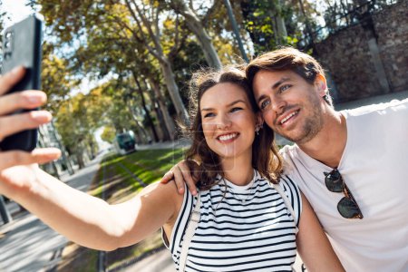 Photo for Shot of lovely couple taking selfies with smartphone in the city - Royalty Free Image