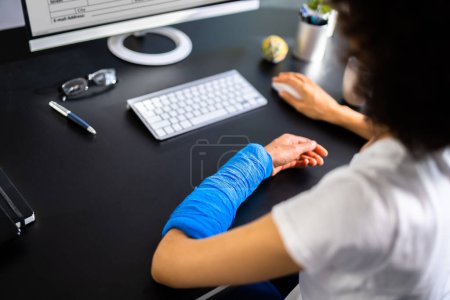 Injured Worker Compensation. Broken Arm African Woman On Computer