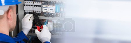 Photo for Electrician Worker Repair And Installation Of Control Box - Royalty Free Image
