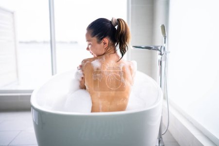 Photo for Beautiful Woman Body Spa Care In White Bathroom - Royalty Free Image