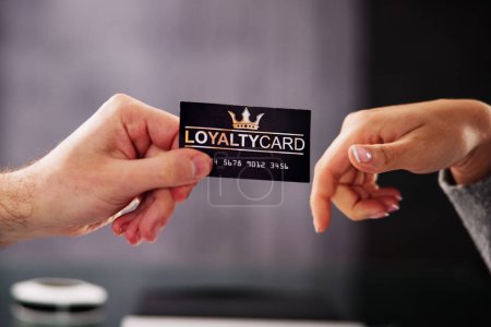 Photo for Businessman's Hand Giving Loyalty Card To His Partner - Royalty Free Image