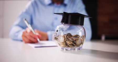 Photo for Piggy Bank With School Education Budget. Graduate Loan - Royalty Free Image