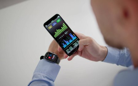 Téléchargez les photos : Hand With Smart Watch And Mobile Phone Showing Heart Beat Rate - en image libre de droit