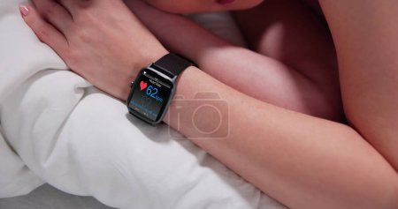 Photo for Fitness Activity Tracker With Heartbeat Rate On Woman's Hand - Royalty Free Image