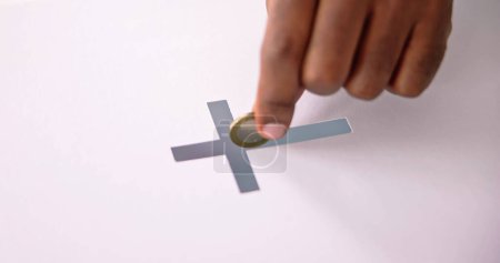 Téléchargez les photos : Hand Inserting Coin In Crucifix Slot. Donate Money - en image libre de droit