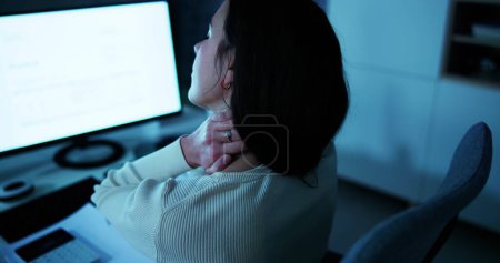 Photo for Young Businesswoman Having Back Pain While Sitting At Office Desk - Royalty Free Image