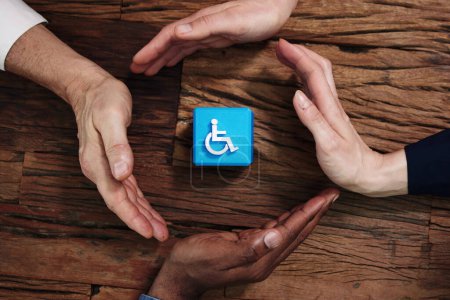 Photo for Close-up Of A Hands Protecting Disability Icon - Royalty Free Image