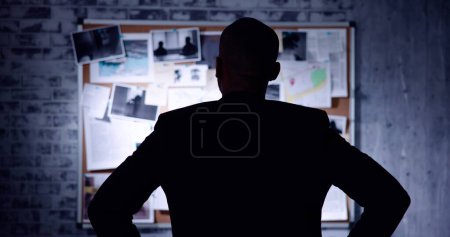 Photo for Policeman Or Private Detective Searching Crime Investigation Board - Royalty Free Image