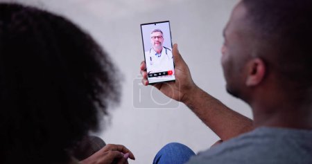 Photo for Online Video Conference With Medical Doctor On Mobile Phone - Royalty Free Image