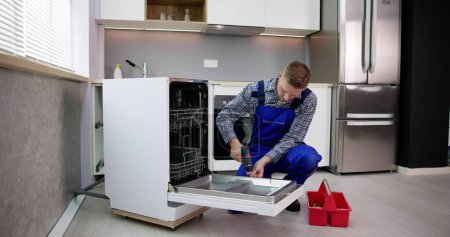 Téléchargez les photos : Dishwasher Appliance Repair Service. Household Maintenance Repairman - en image libre de droit