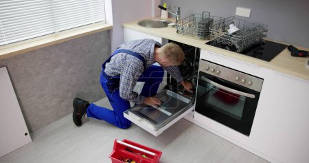 Foto de Dishwasher Appliance Repair Service. Household Maintenance Repairman - Imagen libre de derechos