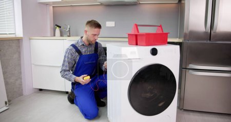 Photo for Washing Machine Repair Problem. Man Fixing Appliance - Royalty Free Image