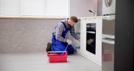 Téléchargez les photos : Services de nettoyage de drain de plombier dans la cuisine. Déboucher le tuyau bloqué - en image libre de droit