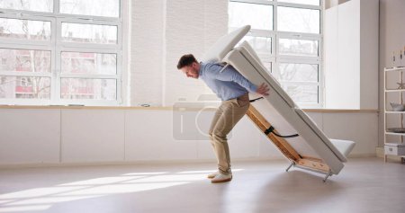 Photo for Men Carrying Furniture. Moving Sofa In Living Room - Royalty Free Image