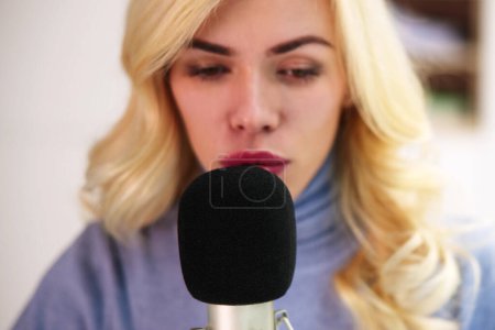 Photo for Young Woman Recording ASMR Sounds On Microphone - Royalty Free Image