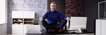 Photo for Employee Doing Mental Health Yoga Meditation In Office - Royalty Free Image