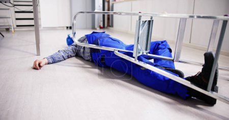 Photo for Unconscious Handyman Fallen From Ladder With Equipments Lying On Floor - Royalty Free Image