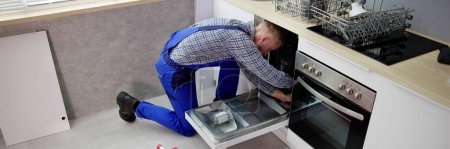 Photo for Dishwasher Appliance Repair Service. Household Maintenance Repairman - Royalty Free Image