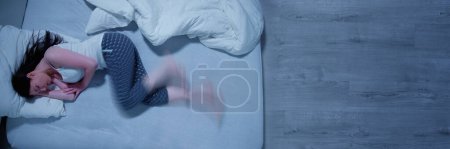 Photo for Woman With RLS - Restless Legs Syndrome. Sleeping In Bed - Royalty Free Image