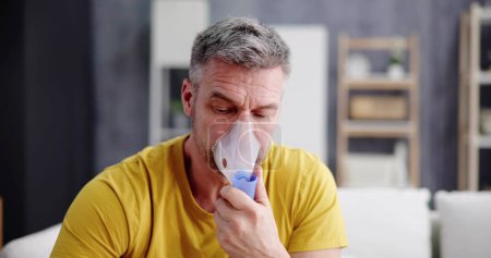 Photo for Asthma Patient Breathing Using Oxygen Mask And COPD Nebulizer - Royalty Free Image