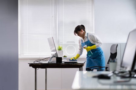 Photo for Janitor Cleaning Office Desk. Hygiene Cleaner Service - Royalty Free Image