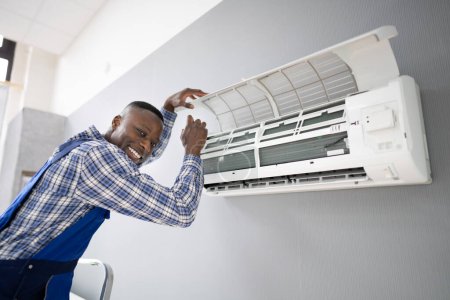 Photo for AC Electrician Technician Repairing Air Conditioner Appliance - Royalty Free Image