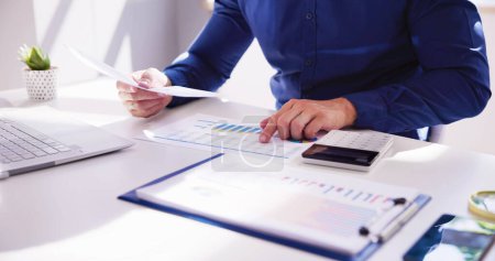 Business Accountant Using Finance Chart Document And Calculator