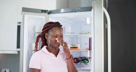 Photo for Young Woman Recognized Bad Smell Coming From The Refrigerator - Royalty Free Image