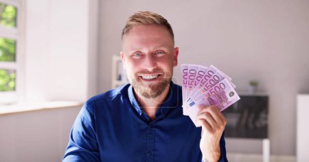 Photo for Man Holding Euro Paper Money Cash In Hand - Royalty Free Image