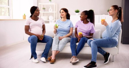 Photo for Pregnant Women Group In Living Room. Fun Chatting - Royalty Free Image