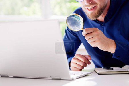 Photo for Tech Counterfeit And Fraud Research Using Magnifier Glass - Royalty Free Image