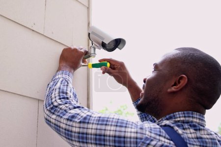 Photo for African American Handyman With CCTV Camera, Security System - Royalty Free Image