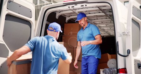 Photo for Truck Movers Loading Van Carrying Boxes And Moving House - Royalty Free Image