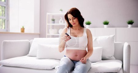 Téléchargez les photos : Femme atteinte de diabète gestationnel à la maison. Mère enceinte - en image libre de droit