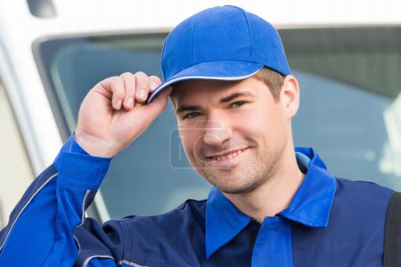 Photo for Portrait of confident pest control worker wearing cap against truck - Royalty Free Image