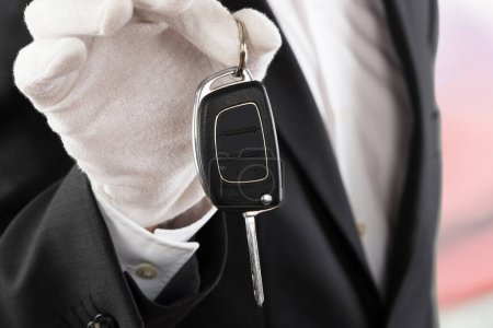 Photo for Close-up Of A Valet Boy Holding A Car Key Outside The Car - Royalty Free Image
