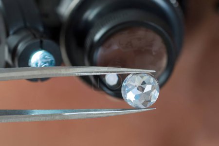 Photo for Close-up Of Person Looking At Diamond With Magnifying Loupe - Royalty Free Image