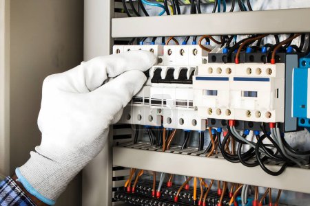 Photo for Photo Of Young African Male Technician Checking Fusebox - Royalty Free Image