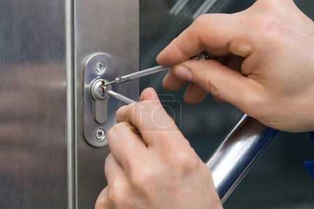 Photo for Mature Male Lockpicker Fixing Door Handle At Home - Royalty Free Image