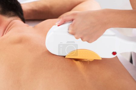 Photo for Hair Removal Cosmetology Procedure From A Therapist At Cosmetic Beauty Spa Clinic - Royalty Free Image
