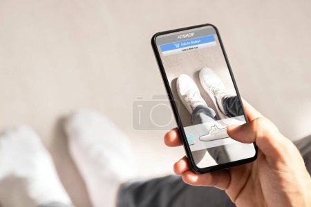 Photo for Man Trying Virtual Sneakers In Shop Or Store AR App - Royalty Free Image