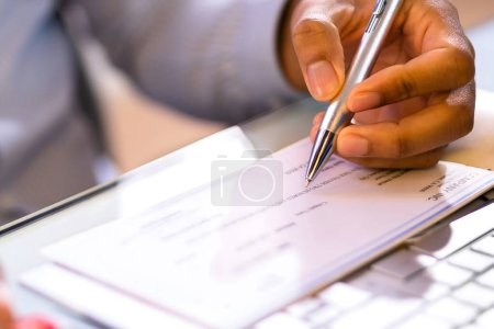 Photo for Writing Payroll Compensation Check. Bank Pay Cheque - Royalty Free Image
