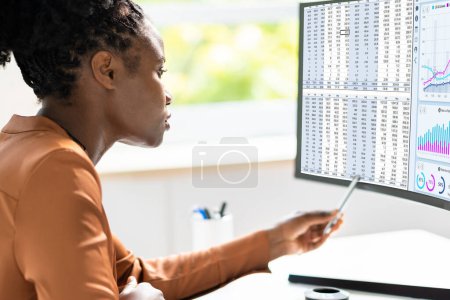 Photo for Black Businesswoman Looking at Data on Computer: A Stock Photo for Analysts - Royalty Free Image