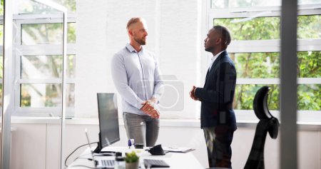 Photo for Two Businesspeople Talking With Each Other At Office - Royalty Free Image